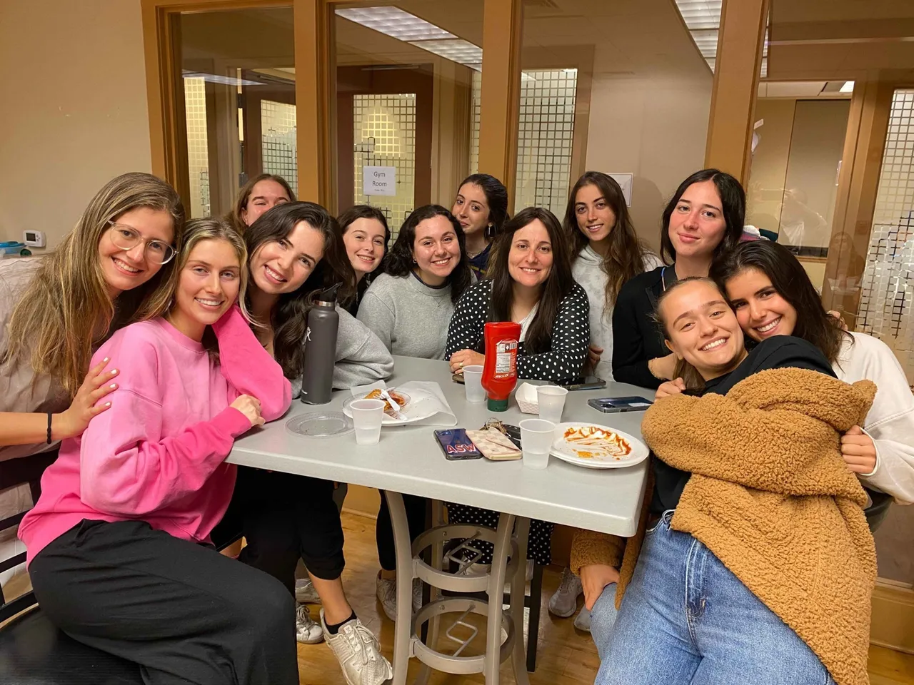 Friends hanging out around a table at Chabad UF