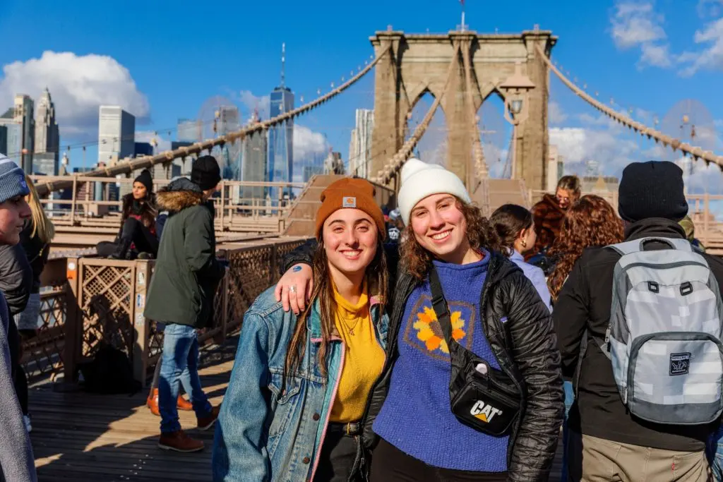 Jewish college students walking across the Brooklyn Bridge during the International Pegisha weekend