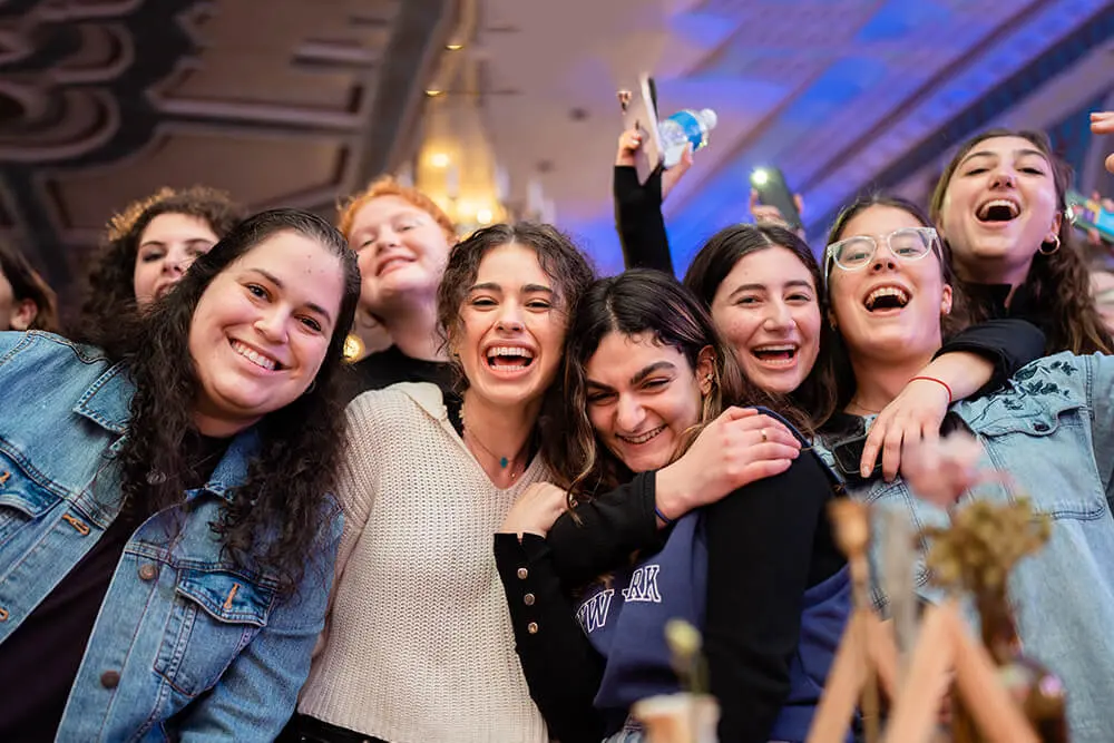 Jewish college students smiling together at a Chabad House