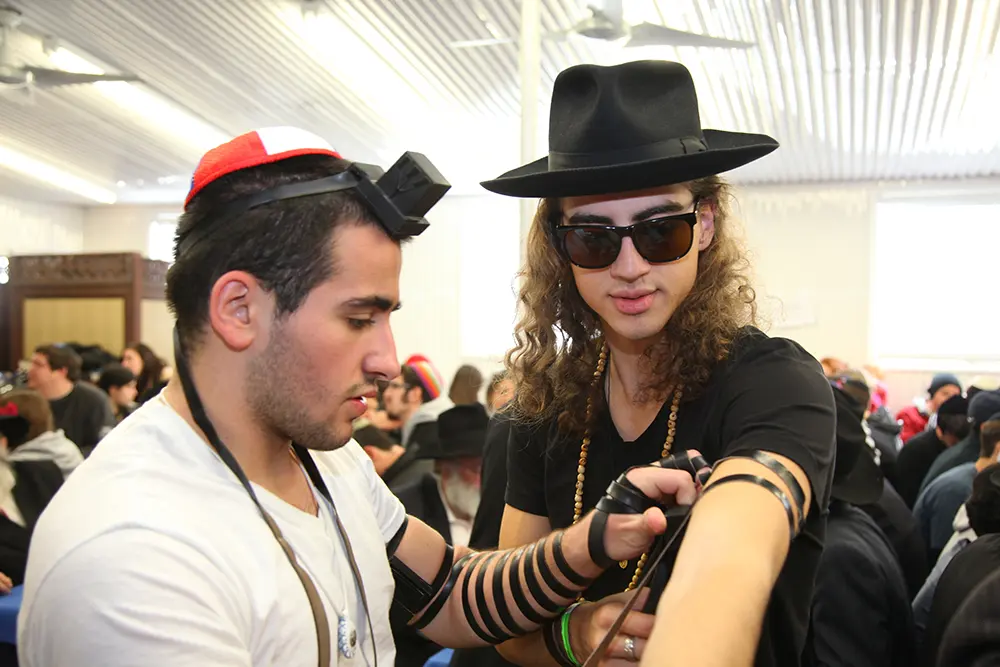 A rabbi helping a college student with a Jewish ritual