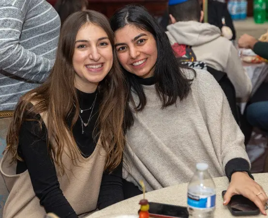 Two Jewish college students smiling together at a Chabad House